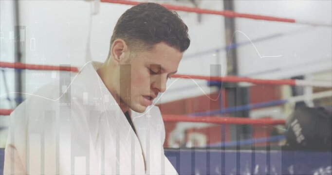 Martial arts student wiping sweat ringside reflecting with fitness graphs guiding determination