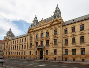A grand and ornate yellow building, characteristic of historical European architecture
