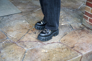Black Platform Shoes on Stone Pavement