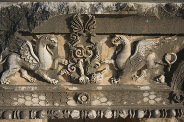 Pilaster capital with griffins, historical ruins of Temple of Apollo. Didim, Turkey.