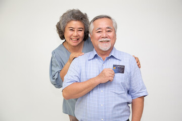 Happy Asian senior couple holding credit card isolated on white background