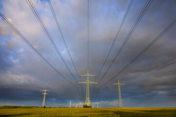 High-voltage power line in high-contrast evening light.