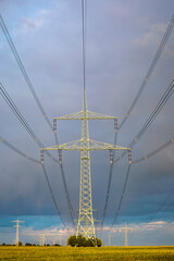 High-voltage power line in high-contrast evening light.
