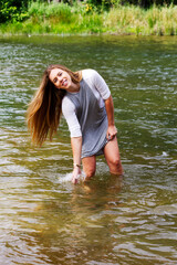 Fototapeta premium Young Caucasian Woman Playing In River Smiling