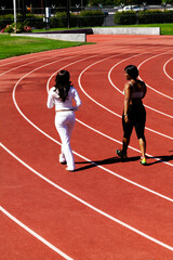 Two African American Woman Walking On Track