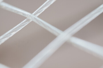 Macro, detailed close-up shot of a tennis racquet's strings. Sports Equipment. Ball Sport and Game concept. Depth of field.