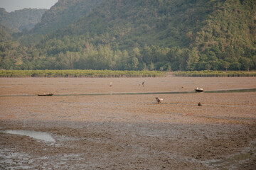 Low tide on the beach at sunset, Ha long bay, Vietnam