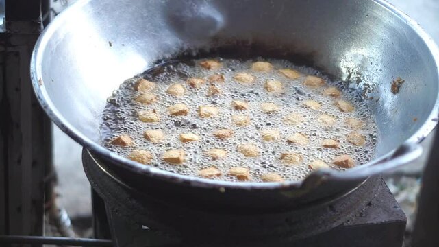Sumedang tofu, fried in a frying pan using a gas stove