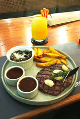 Steak Dinner with French Fries and Orange Juice