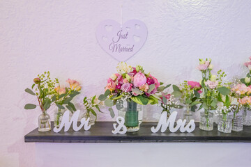 Wedding decor. Close up of a wedding table decoration with white and pink flowers and candles Wedding floristic concept