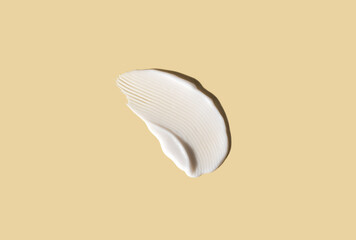 Cosmetic smear of cream texture on pastel yellow background. Skin care.