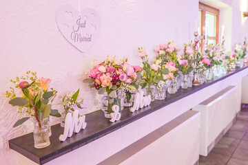 Wedding decor. Close up of a wedding table decoration with white and pink flowers and candles Wedding floristic concept
