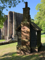 Old brick and timber outbuilding standing beside Furness Abbey’s historic ruins.