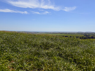 Expansive rural view near Dalton-in-Furness, showing farmland and rolling hills under a clear sky.