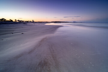 Paradise coast of Coche Island in the morning. Delicate purple, blue sky over the beach. Venezuela, South America. Peaceful and quiet morning on the beach.	
