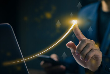 Businessman pointing at rising arrow graph symbolizing business growth, success, digital strategy, data analytics, and financial progress in the modern digital era.