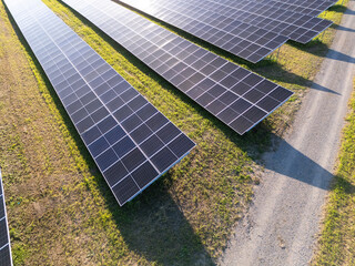 Aerial view of solar power station on a green field. Sustainable development.