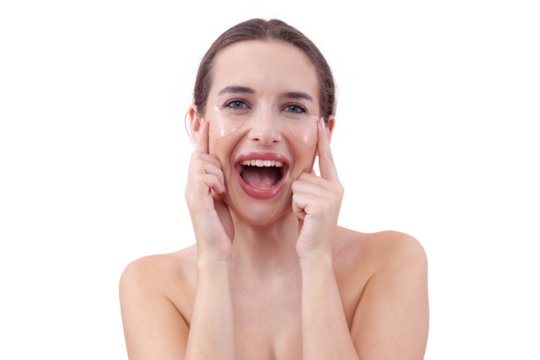 Portrait of happy young woman with a natural, no makeup look, applying silicone under eye patches and laughing while looking at the camera. Skincare concept for dark circles, isolated white background