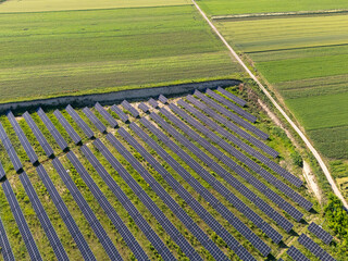 Aerial view of solar power station on a green field. Sustainable development