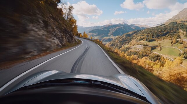 Driving adventure through scenic mountain roads in the Alps during autumn season