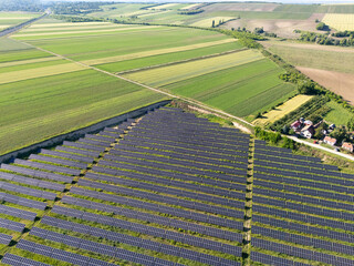 Obraz premium Aerial view of village next to solar power station