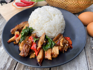Grilled Chicken with Thai Basil and Rice &ndash; Spicy Asian Stir-Fry Dish on Black Plate