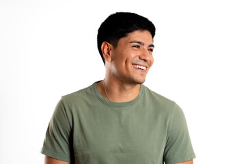 Young Latin man,in profile, smiles and looking away, in white background
