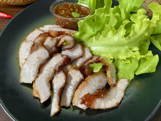 Grilled Pork Neck with Spicy Thai Dipping Sauce and Fresh Lettuce – Traditional Thai Food on...