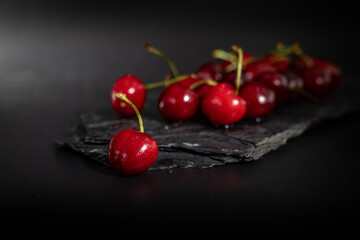 cherries on a black background