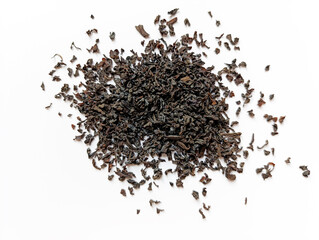 Loose black tea leaves scattered on a white surface showcasing their rich texture and deep color