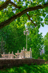 An old architectural detail made of white concrete with a street lamp