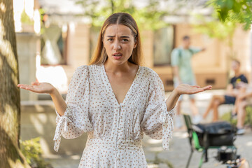I don't know what to say. Confused young woman feeling embarrassed about ambiguous question having...