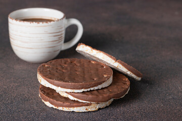 Milk chocolate coated rice cakes, gluten free and cup of coffee