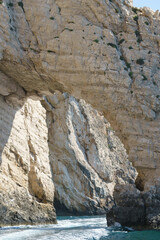 View through rugged sea caves near Myzithres rocks, Zakynthos island. Famous white limestone cliffs dramatically contrast with the vibrant turquoise blue waters of the Ionian Sea, Greece.