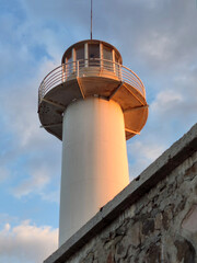 Port lighthouse tower against the sky. View from below