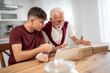 Grandfather and grandson running small business from home