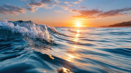 Obraz premium A breathtaking sunset casts warm colors across rippling ocean waves, creating an awe-inspiring scene that captures the beauty and energy of nature's spectacles.