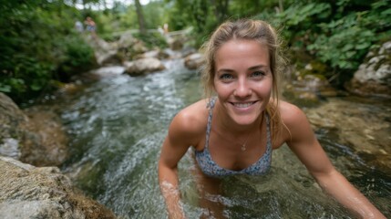 Fototapeta premium A joyful woman swims in a tranquil stream, embracing the refreshing waters of nature, highlighting the essence of outdoor fun and the beauty of the natural environment.