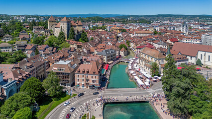 Aerial view of the historic center of Annecy, of the Palais de l'Isle on the River Thiou and of the Castle of Annecy, a lakeside city located in Haute-Savoie, Auvergne-Rhônes-Alpes, France © Alexandre ROSA