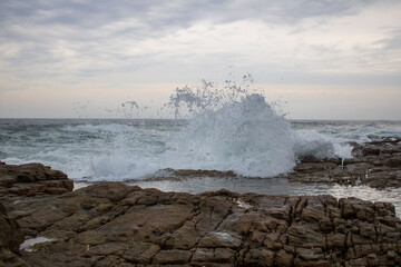 Various waves from the ocean crashing onto the rocks on the south coast of South Africa, located at Orange Rocks in Uvongo in Margate