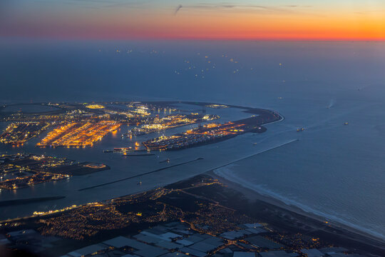 Aerial night view of Port of Rotterdam terminal and shipping lanes