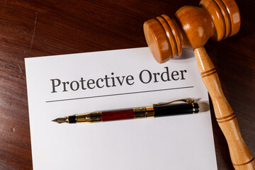 Protective Order Paper Set on Judge’s Desk with Gavel and Pen – Legal Protection Concept