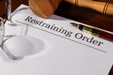 Restraining Order Document on the Desk with Gavel and Pen – Legal Protection and Court Order Concept

