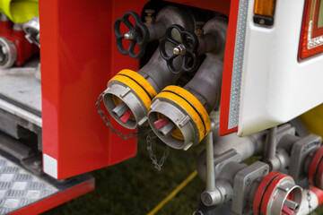Close-up of fire truck equipment with dual hoses and valves