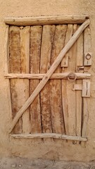 An old wooden door with a rustic and weathered surface, showcasing vintage charm and historical texture abandoned heritage house.