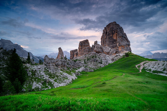 Majestic rock formation Cinque Torri in the Dolomites in Italy at sunset. Picturesque meadows in the mountains.