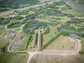 Large, empty lot with a blue house in the middle
