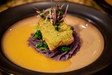 Herb-crusted fish on smooth sweet potato 