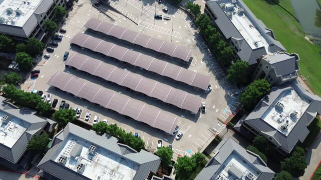 Shade structure covered parking carport canopy, commercial rooftop HVAC package units of office space for rent, riverside leasing corporate campus in Las Colinas, Irving, suburbs Dallas, flyover