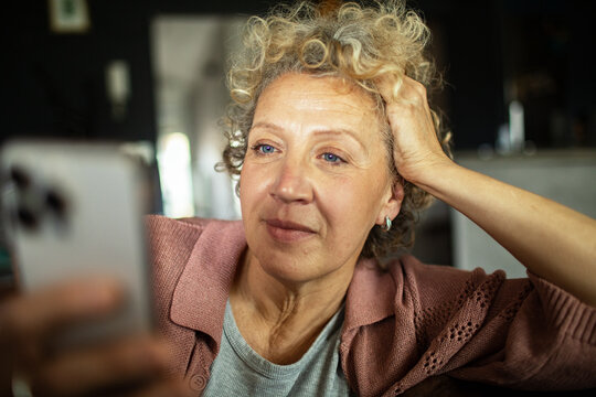 Close up of a senior woman looking at her smartphone at home